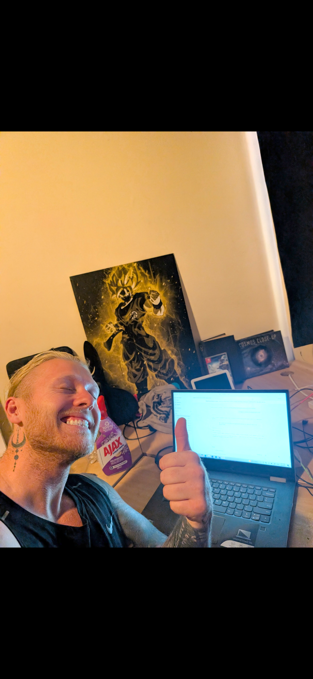 Shannon smiling beside his laptop while building Balance on the Gold Coast